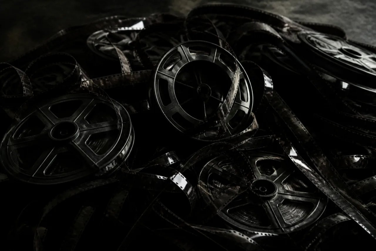 A dark tangle of scattered camera lenses